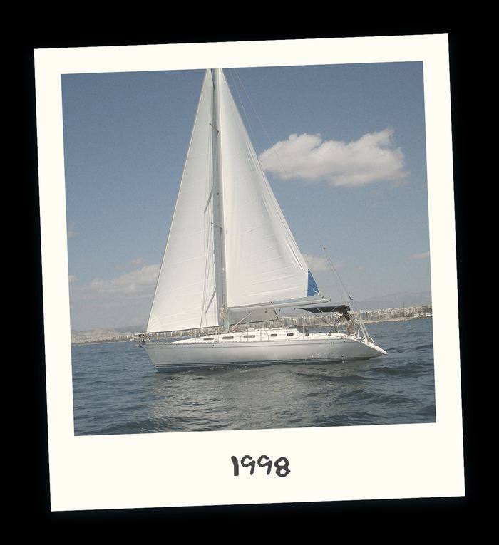 Polaroid of a Sailing Yacht under white sails in open water in 1998
