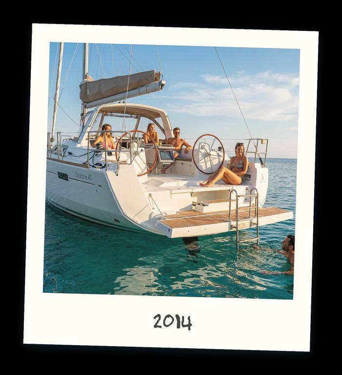 Polaroid of guests aboard a modern chartered monohull at anchor in 2014