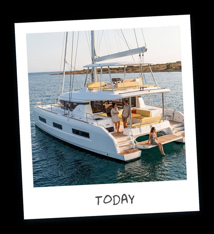 Polaroid of a crewed charter catamaran at anchor with guests on the aft deck today