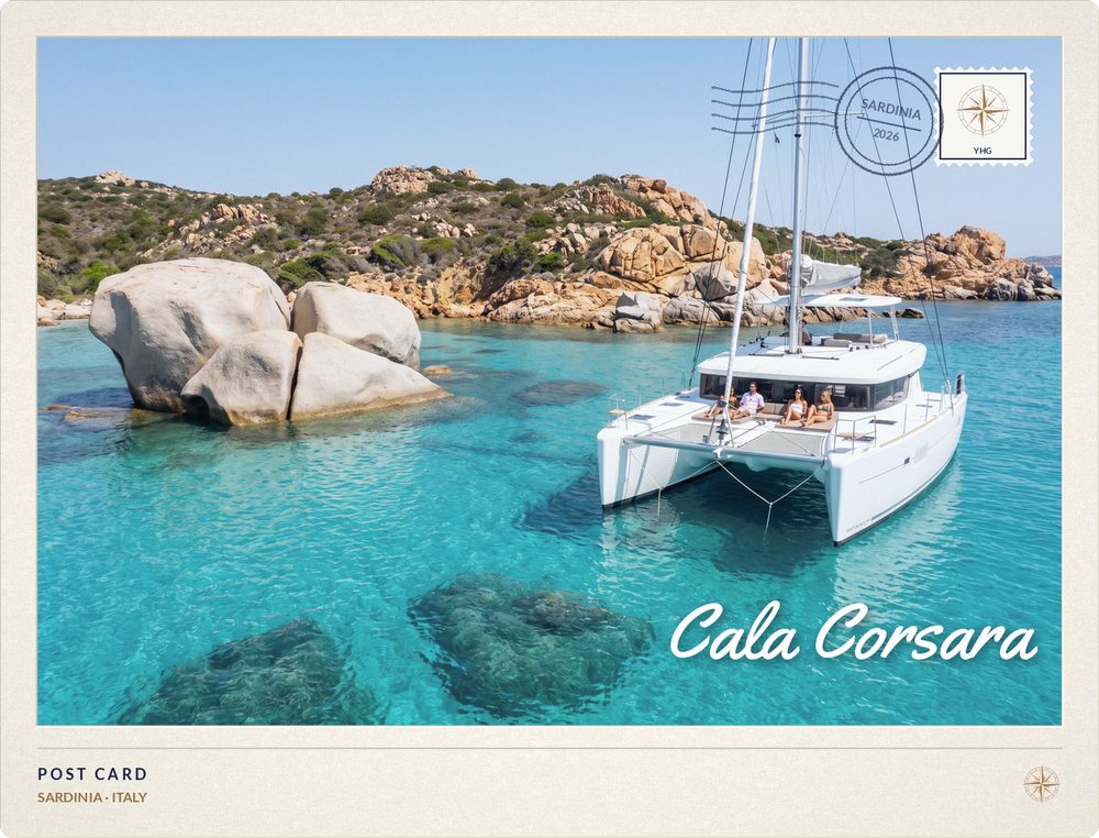 Postcard of a Sailing Catamaran anchored off the granite and white sand of Cala Corsara, Sardinia